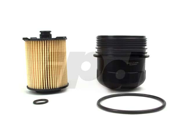 Genuine Volvo oil filter with housing and mechanic tools neatly arranged on a clean workbench.