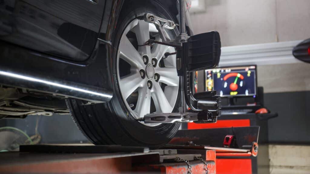 Car on stand with sensors on wheels for wheels alignment camber check in workshop of Service station wheel alingment service