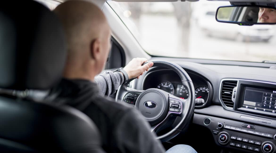 elderly businessman driving scaled