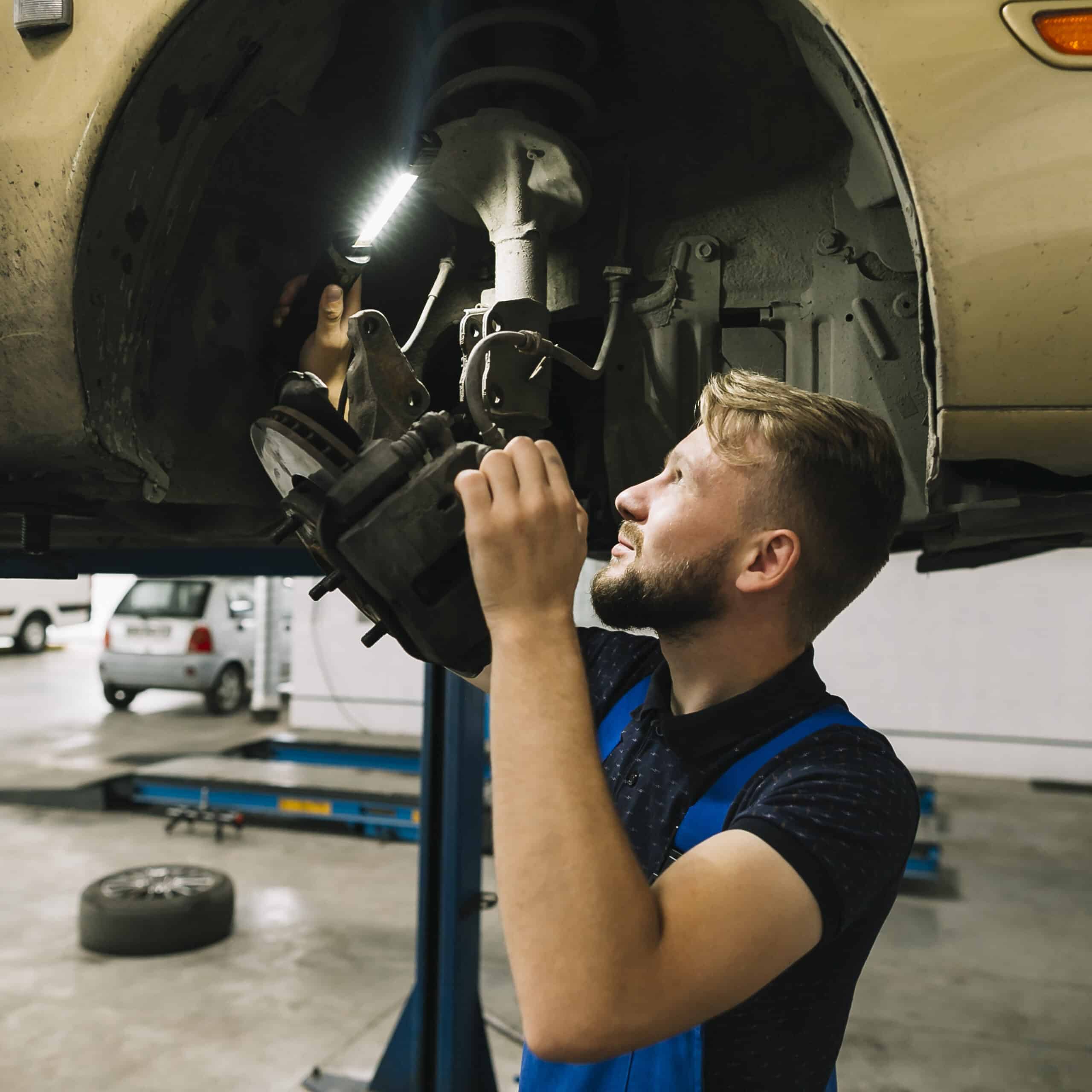 repairmen examining wheel structure scaled