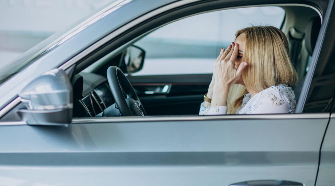 elderly woman testing car car showroom