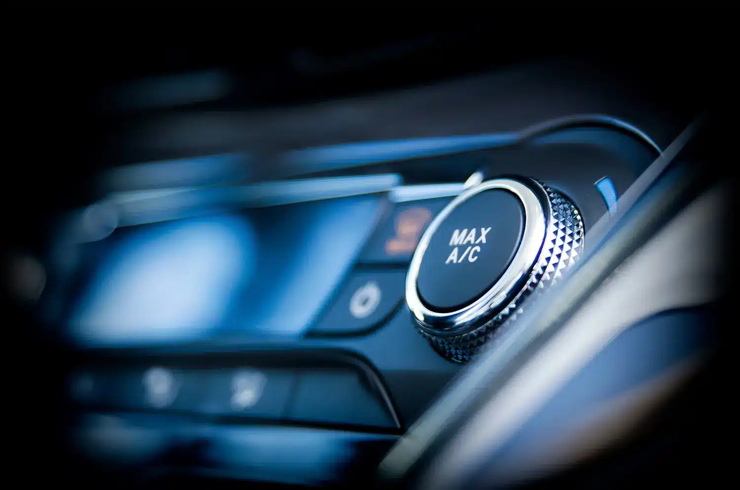Close-up of vehicle climate control dial labeled "MAX A/C," highlighting air conditioning functionality relevant to automotive climate control services.