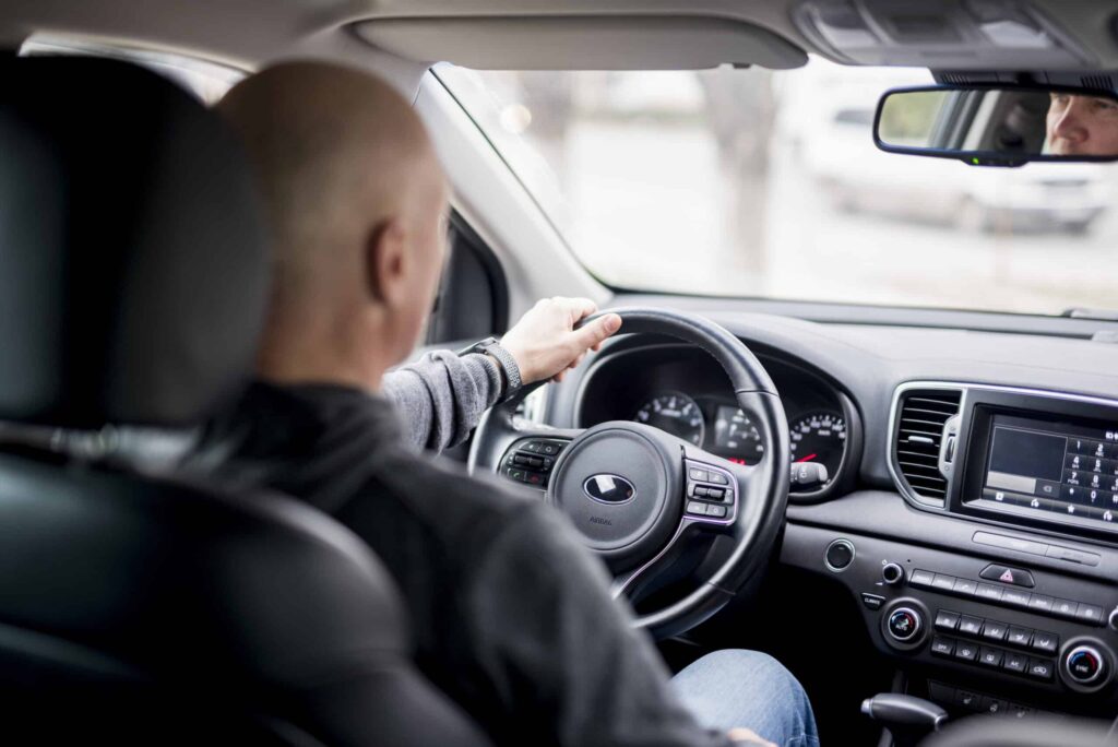 elderly businessman driving scaled 1