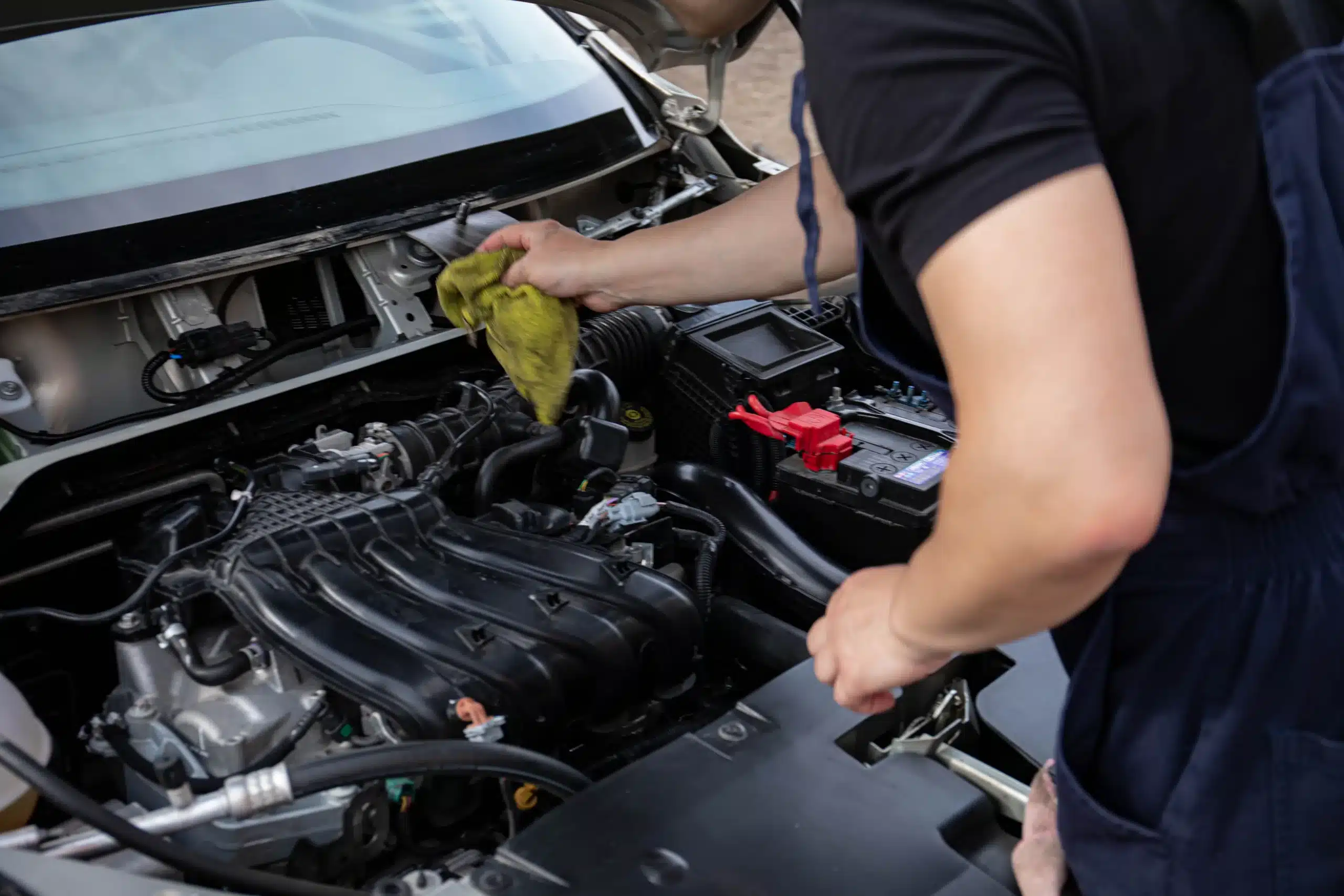 MB Automotive technician inspecting Audi engine components and performing maintenance.
