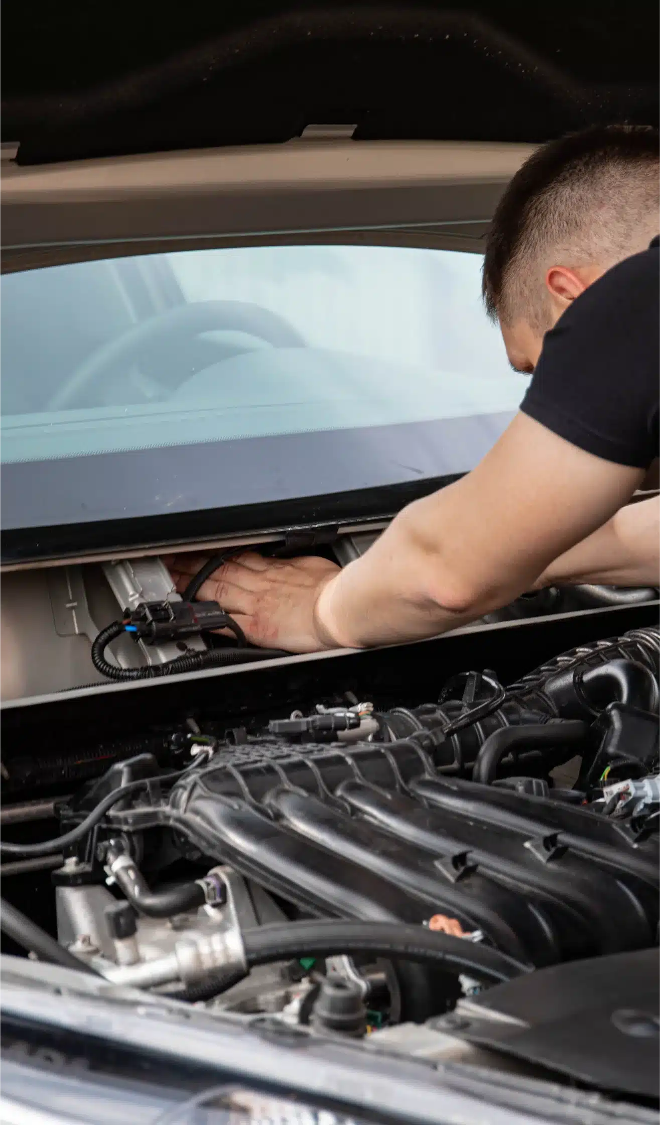 MB Automotive technician performing BMW engine diagnostics and repair in Bay Shore.