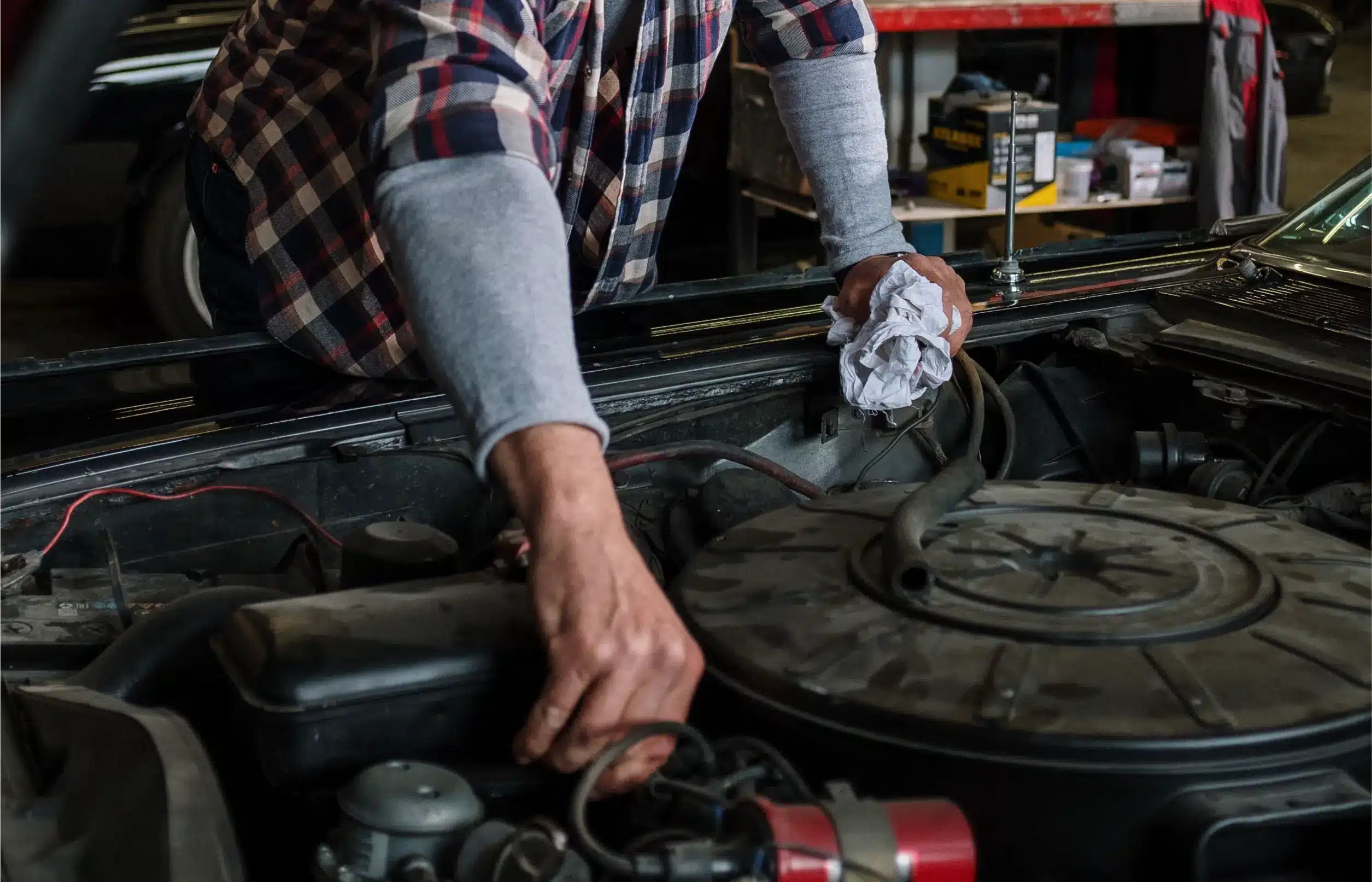 MB Automotive technician inspecting Volvo engine components in Bay Shore repair shop.