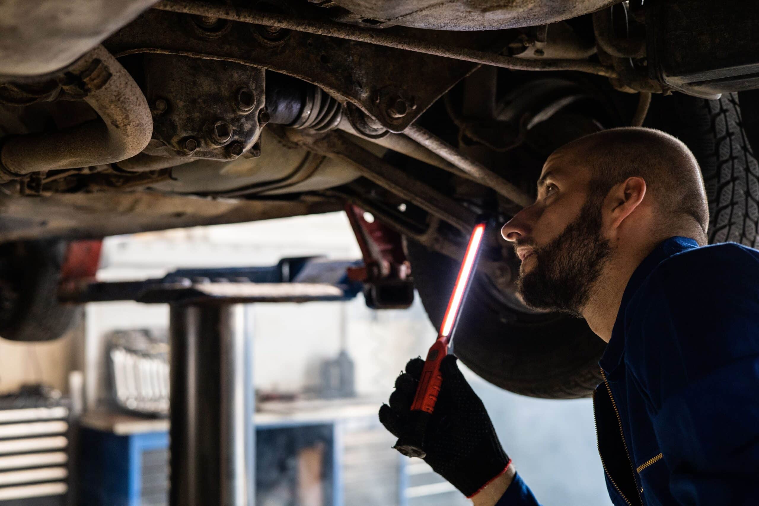 Mechanic checking engine light emphasizing the importance of regular maintenance
